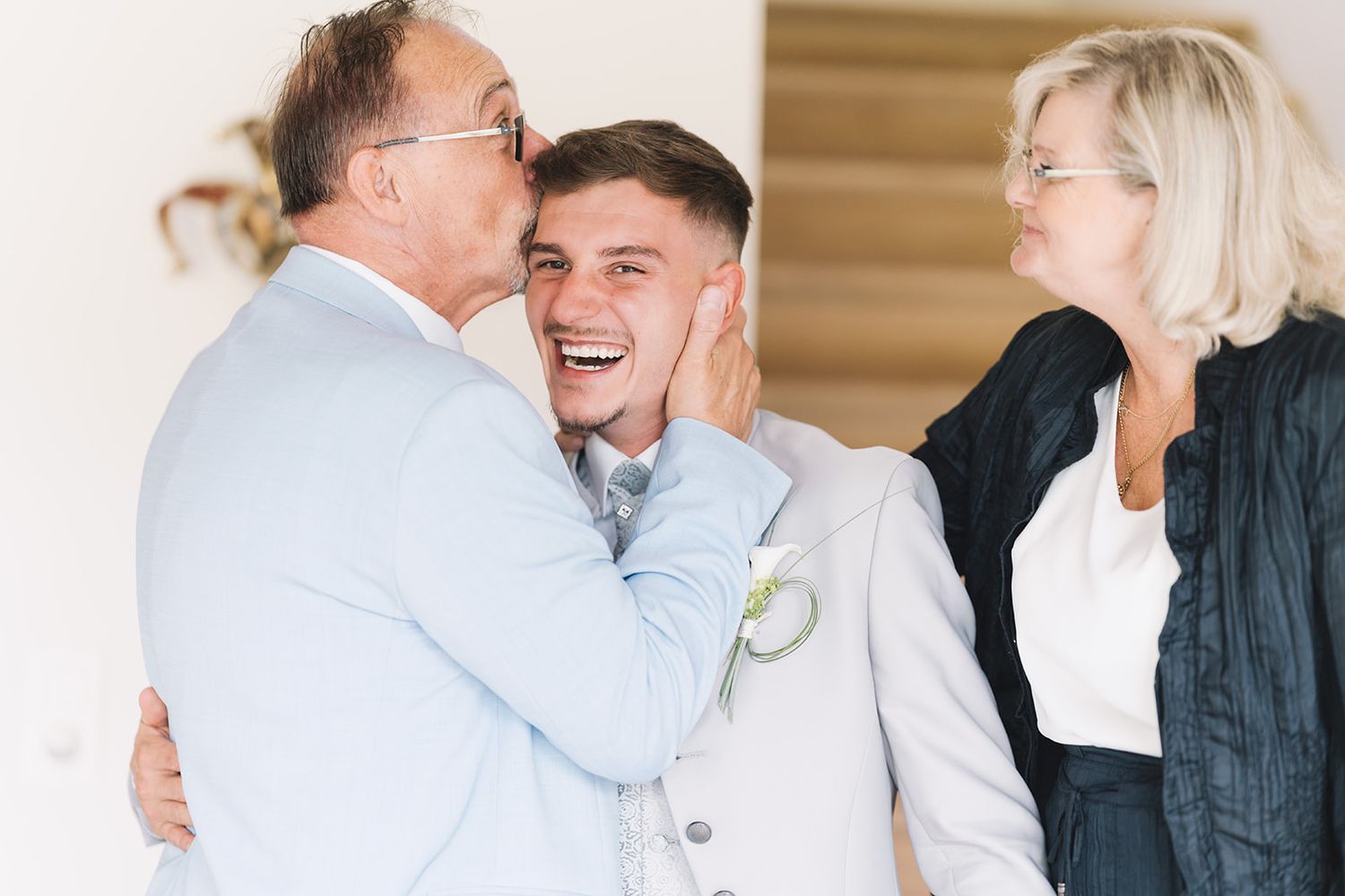 Emotional candid moments shared between wedding party members in formal attire.