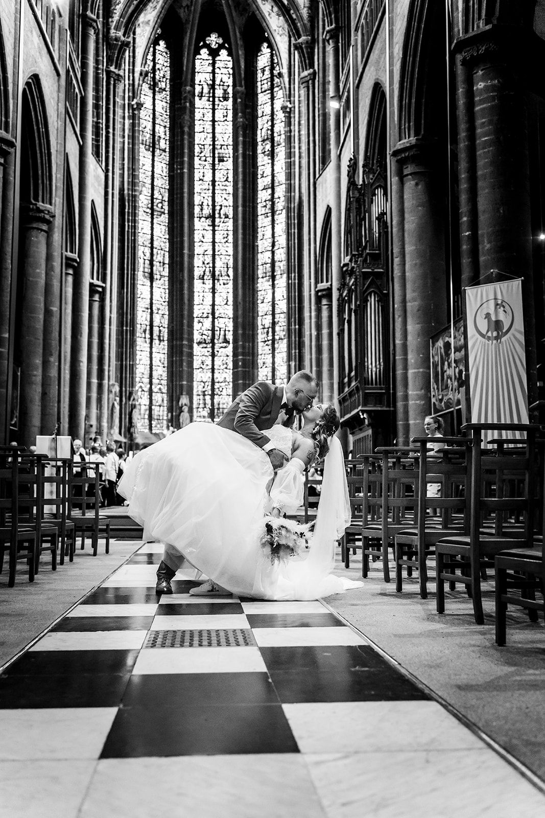 Dramatic black and white photos show flowing dress movement in Gothic church interior.
