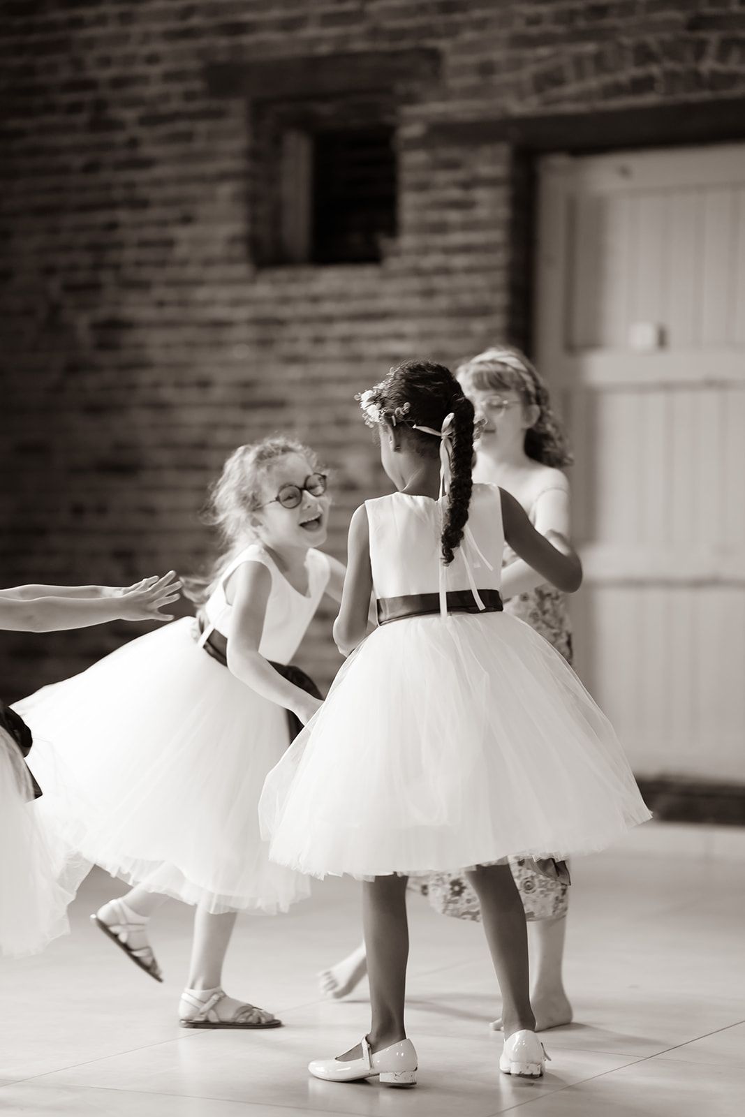Young dancers in white tulle dresses twirl during a performance.