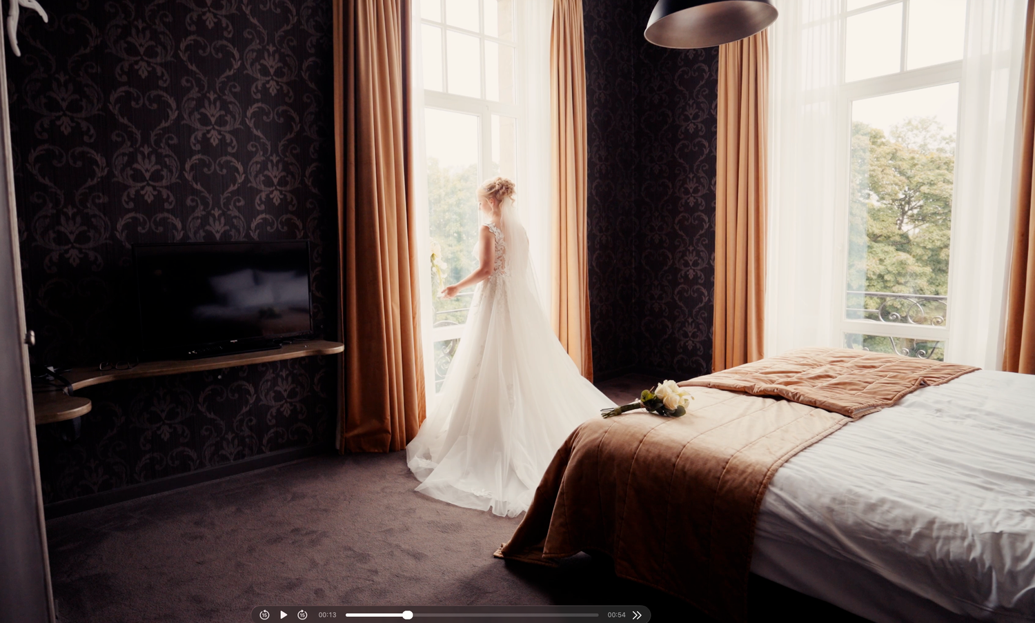 Portrait de la mariée en robe blanche devant une grande fenêtre, ambiance lumineuse et sereine au Château de Namur.