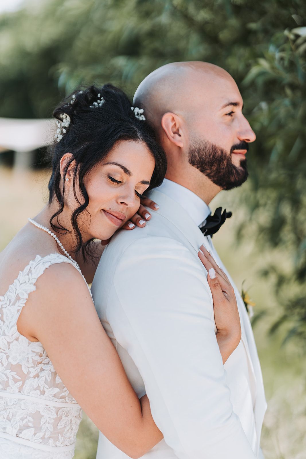 Intimate outdoor wedding portrait capturing a tender embrace.