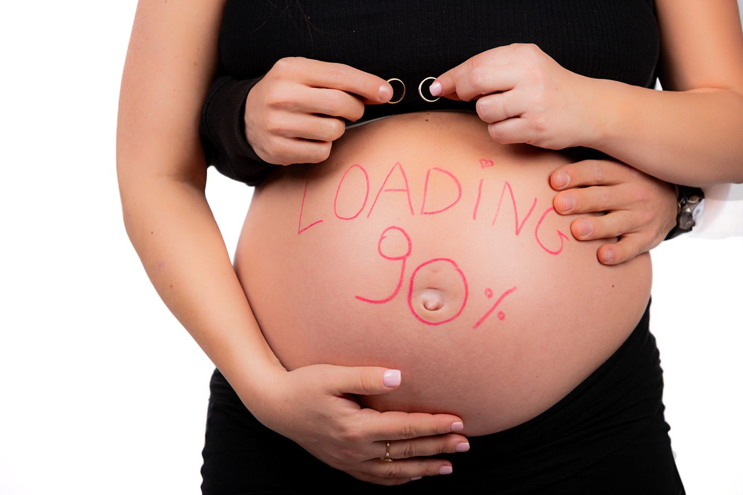 Maternity photo series showing pregnant belly with text written in pink.