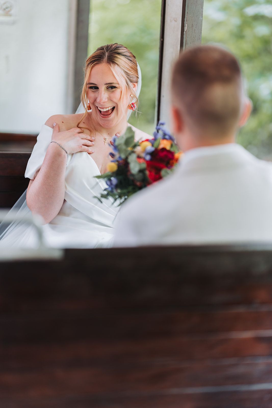Candid moment of bride laughing during wedding celebration.