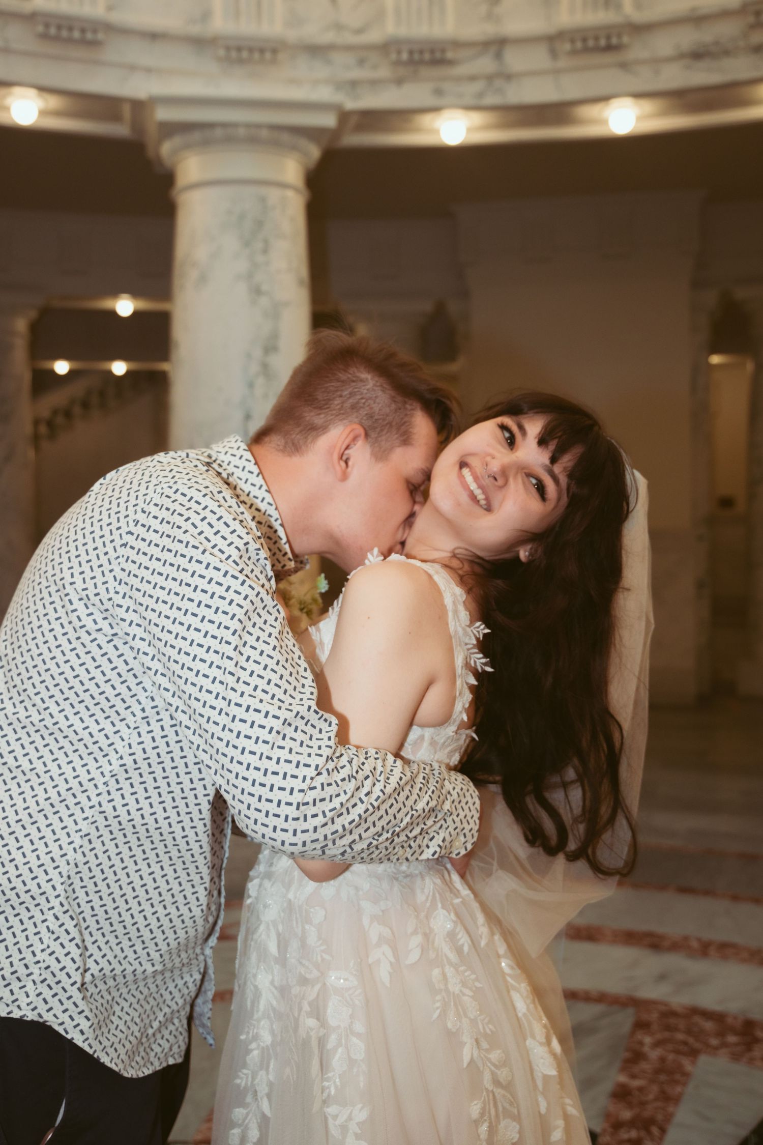 An elegant indoor wedding scene with ornate architectural details and romantic lighting.