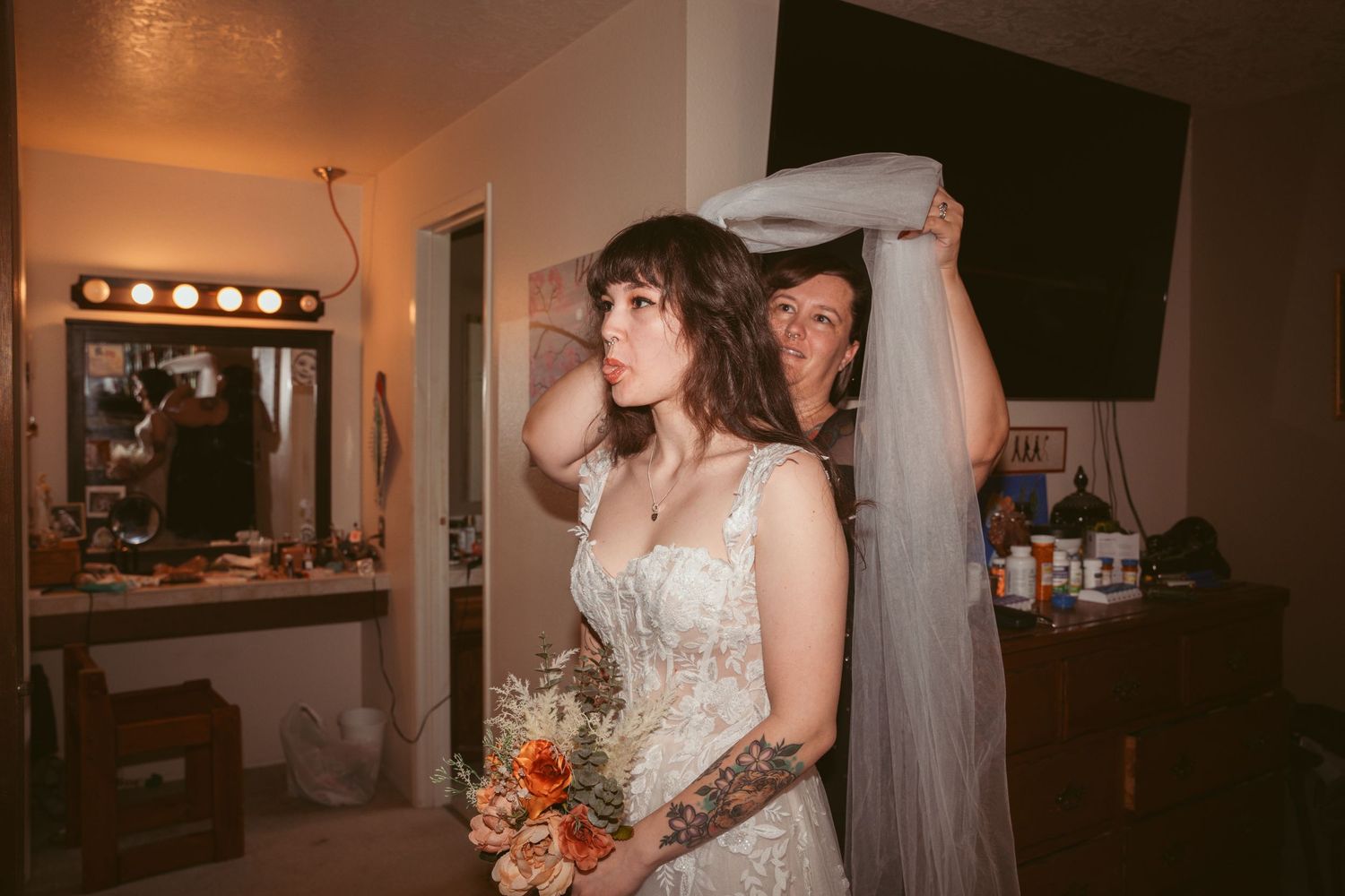 Wedding party gathered in a dimly lit room with warm lighting.