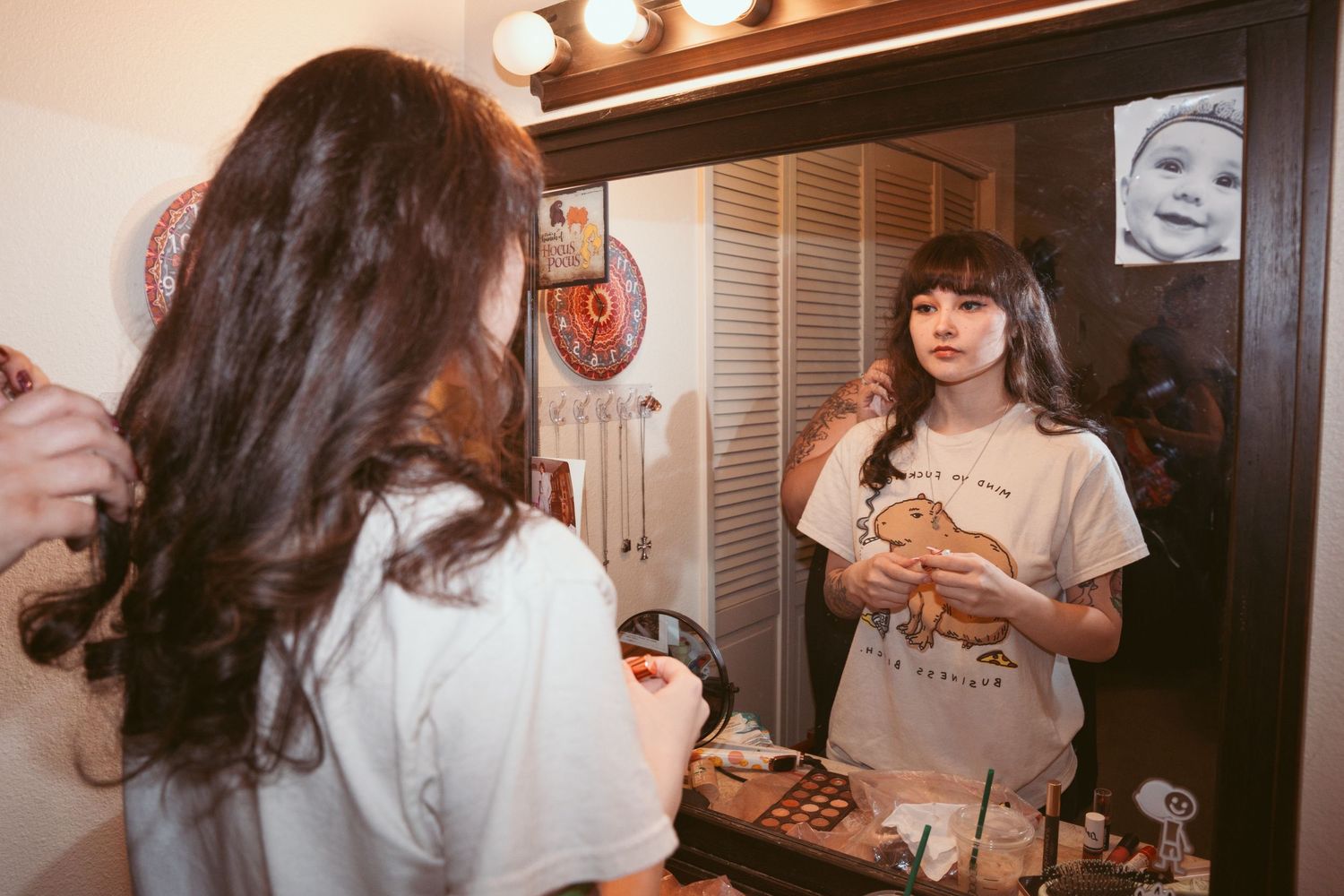 Vintage-style getting ready scene with warm lighting and vanity mirrors.