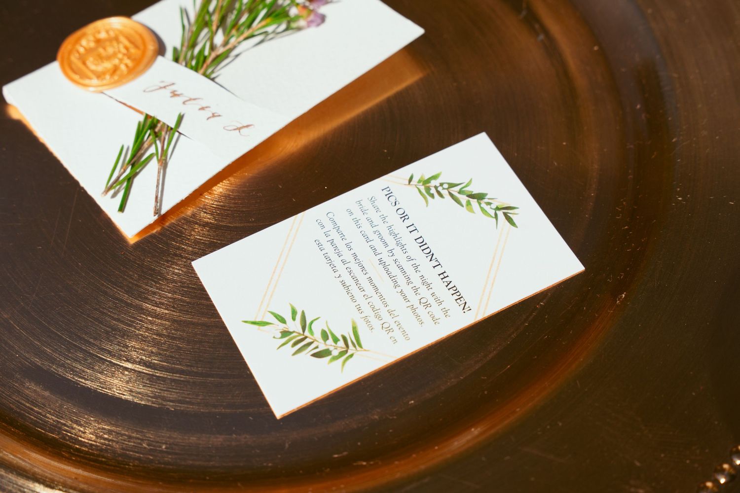 Wedding menu cards with floral details arranged on dark wooden surface.