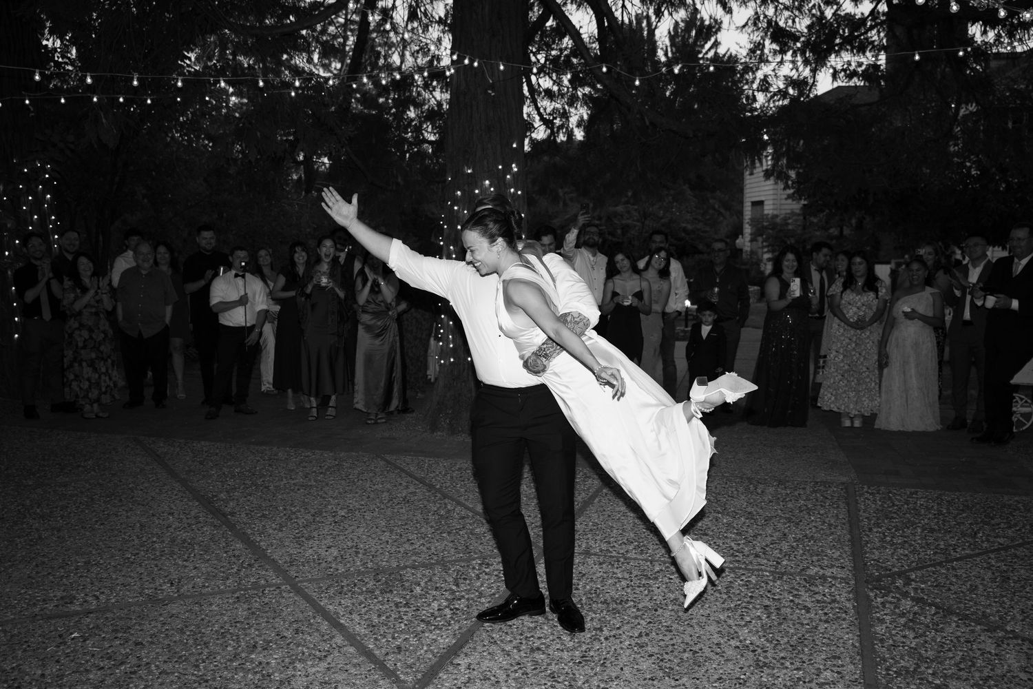 Black and white photos capturing dynamic dance moves at a wedding reception.
