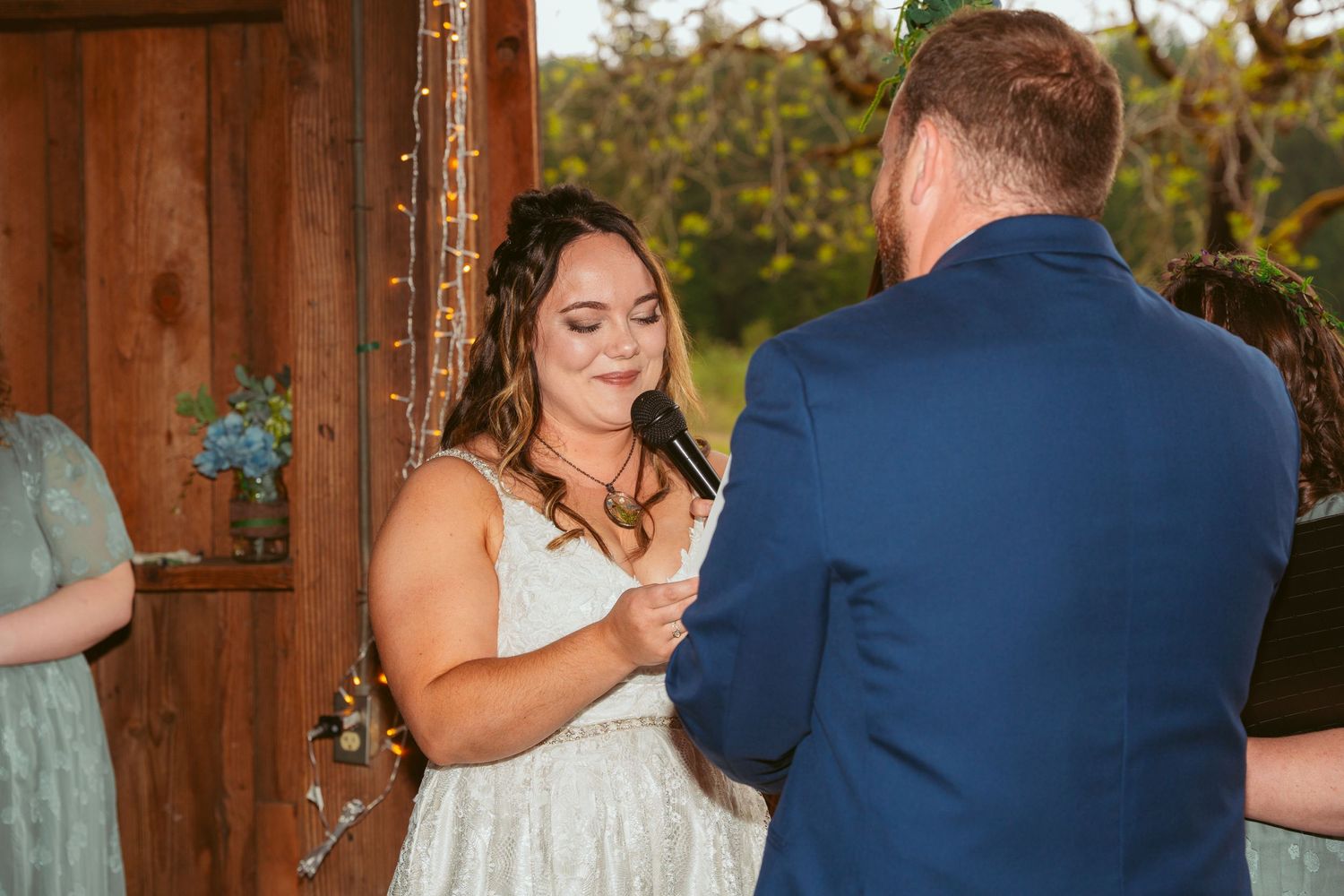 Candid wedding moments captured inside rustic barn with natural lighting.