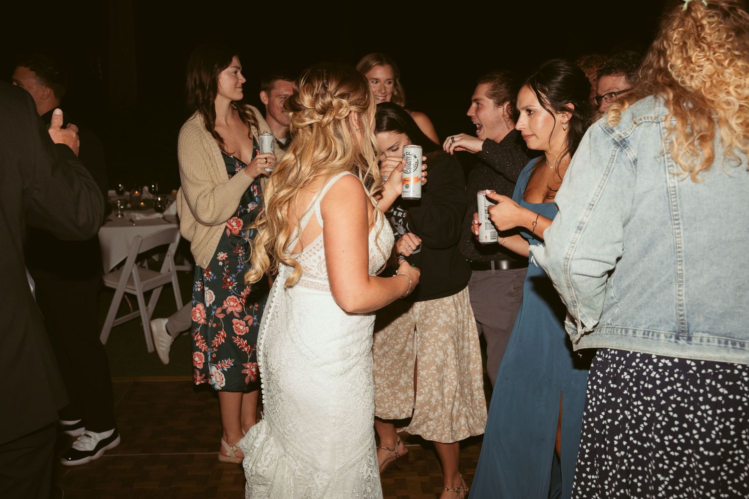 Wedding celebration on an outdoor dance floor with guests enjoying the evening festivities.
