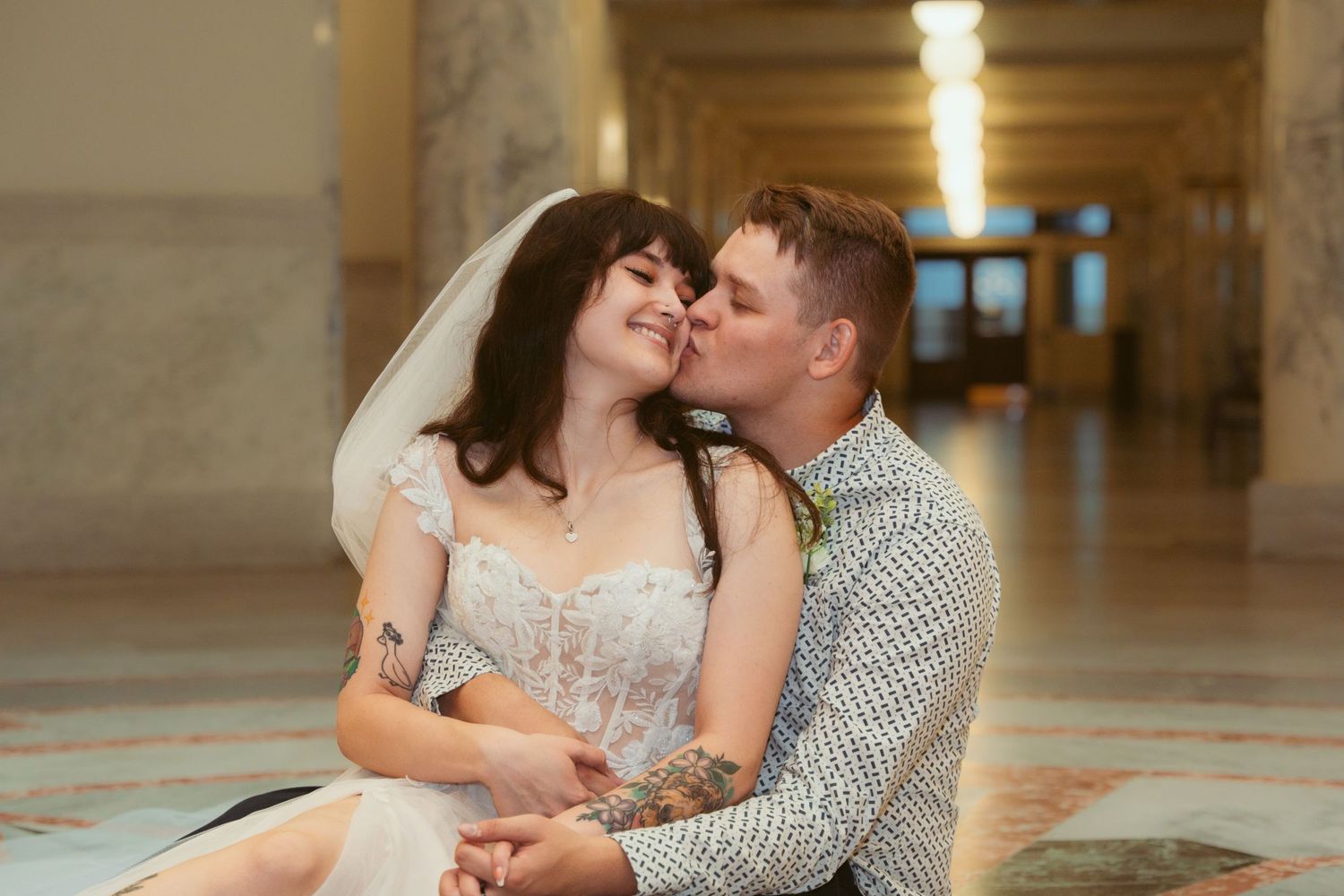 A romantic moment captured between a couple in an elegant indoor setting.