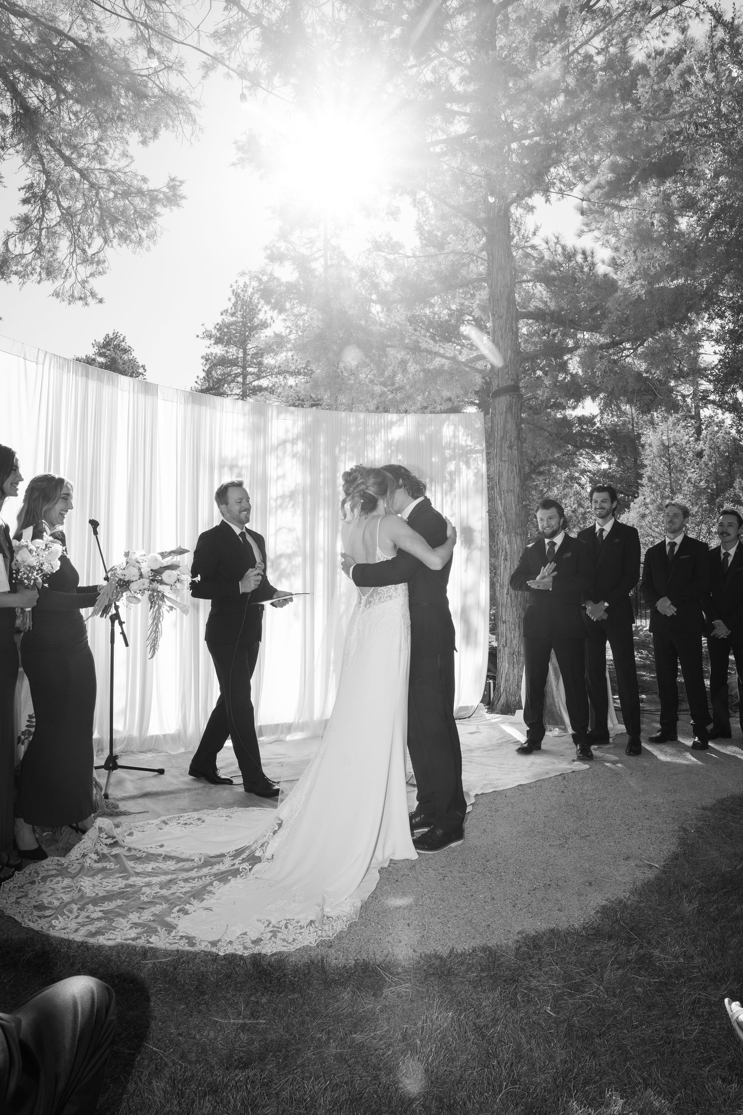 Black and white photo of wedding ceremony first dance with natural forest backdrop.