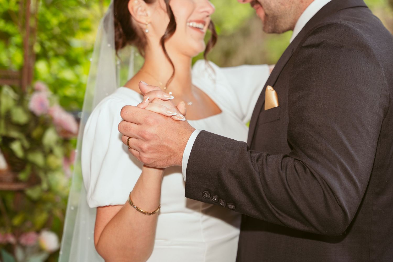 Close-up of newlyweds sharing an intimate moment during their garden wedding.