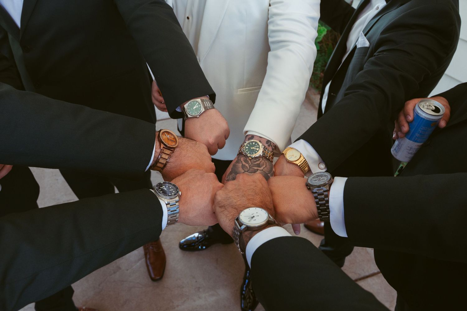 People's hands holding up wine glasses in a celebratory toast at an event or gathering.