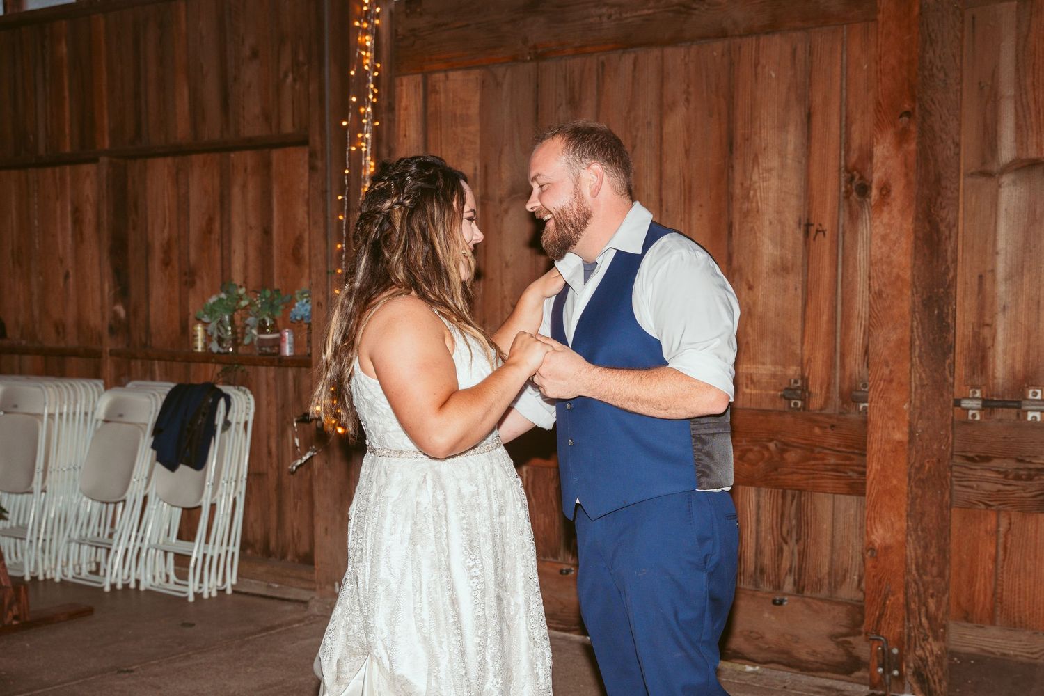 Dancers move gracefully across a barn floor during an evening celebration.