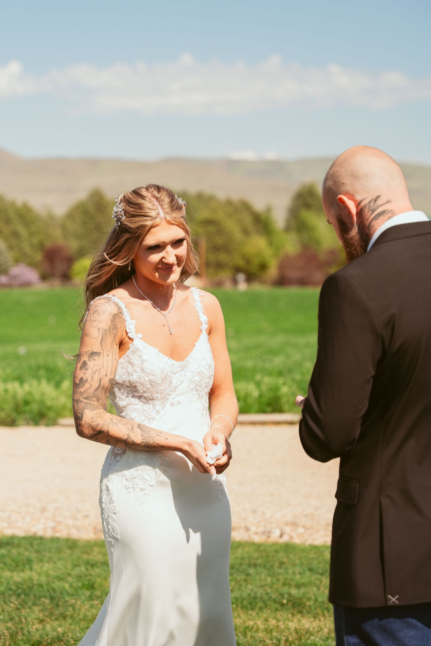 Wedding ceremony moment captured in outdoor setting with mountain landscape.