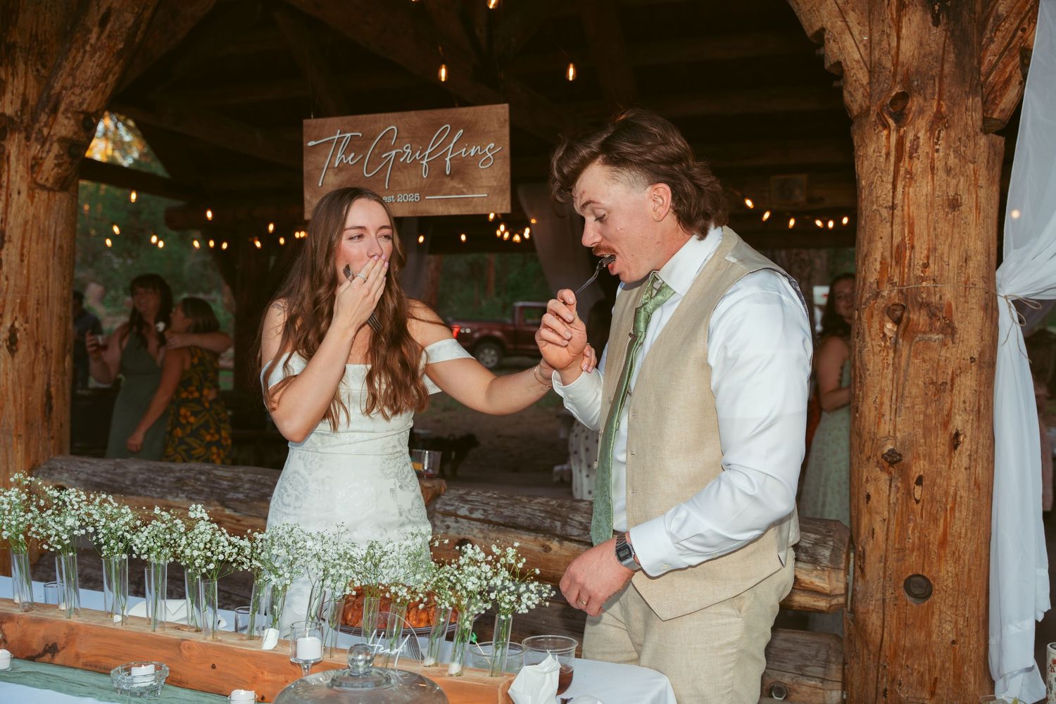 Rustic barn wedding venue decorated with string lights and white fabric for an elegant reception.