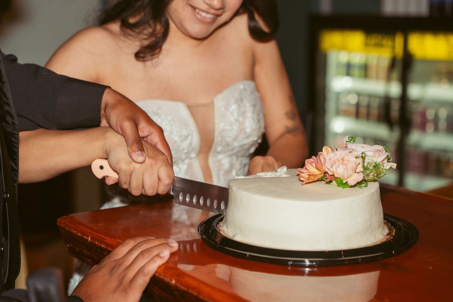 Close-up shots of wedding cake cutting ceremony with vintage-style lighting effects.