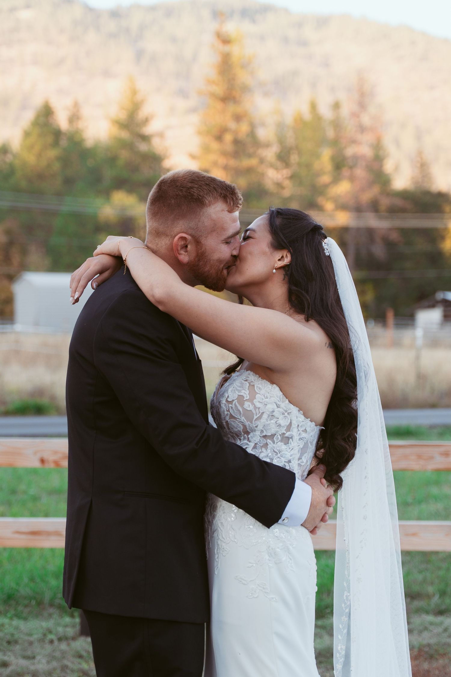 Romantic wedding portraits with mountain backdrop during sunset.