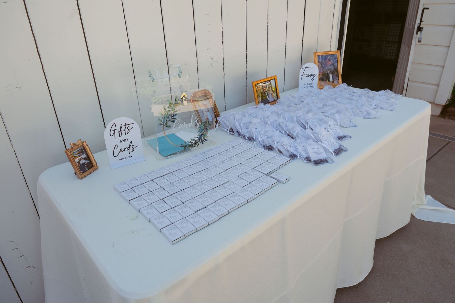 White reception table with guest book and registration materials.