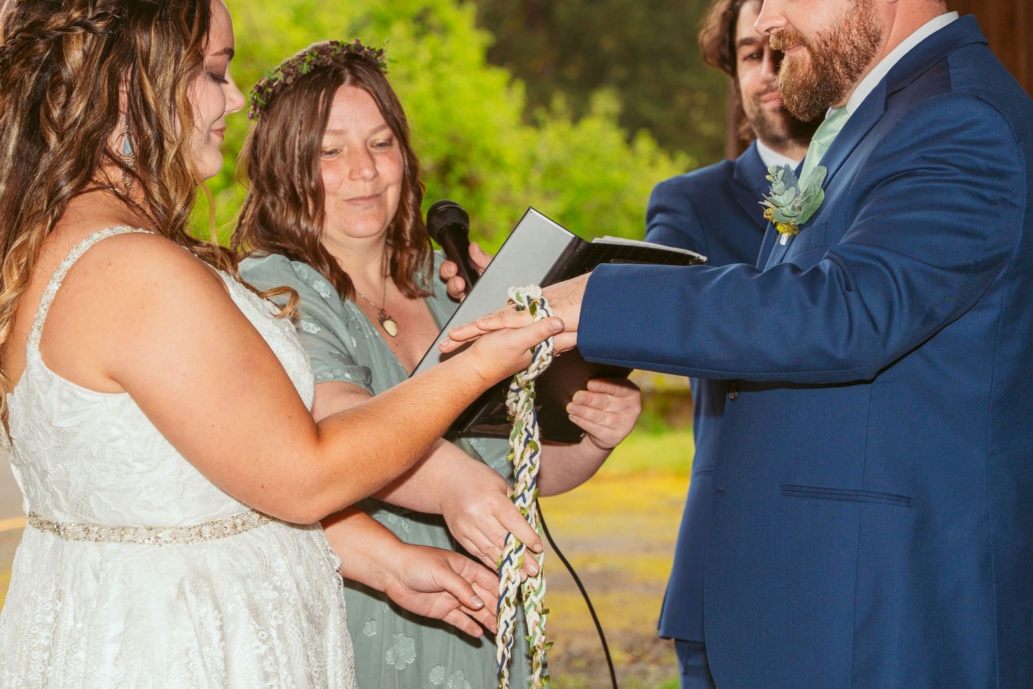 Couple sharing emotional moment during wedding ceremony in wooden barn venue.