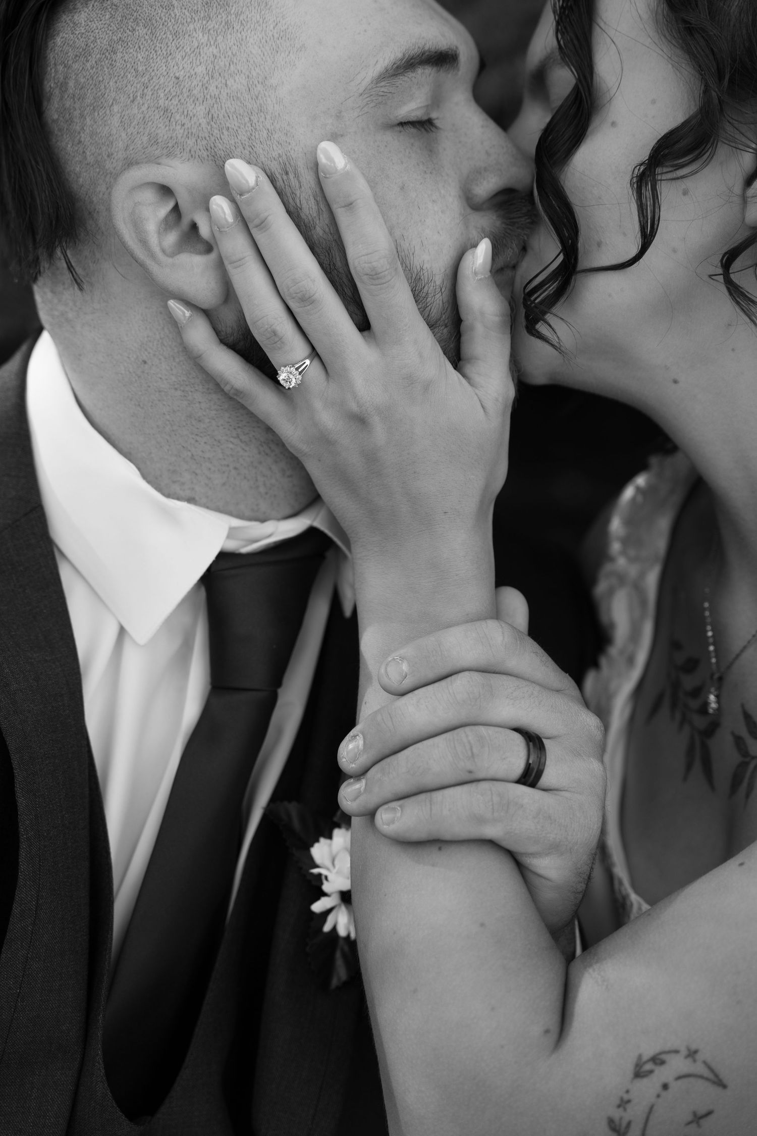 Intimate black and white close-up of a tender moment between newlyweds.