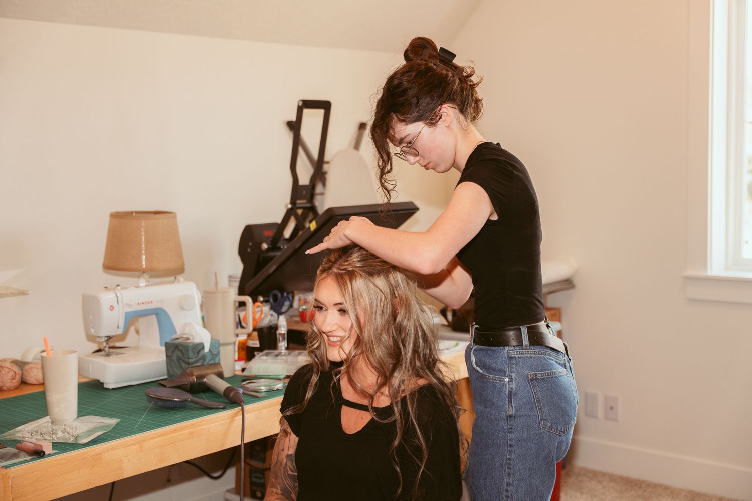 Hair styling session in progress at a beauty preparation station with natural lighting.