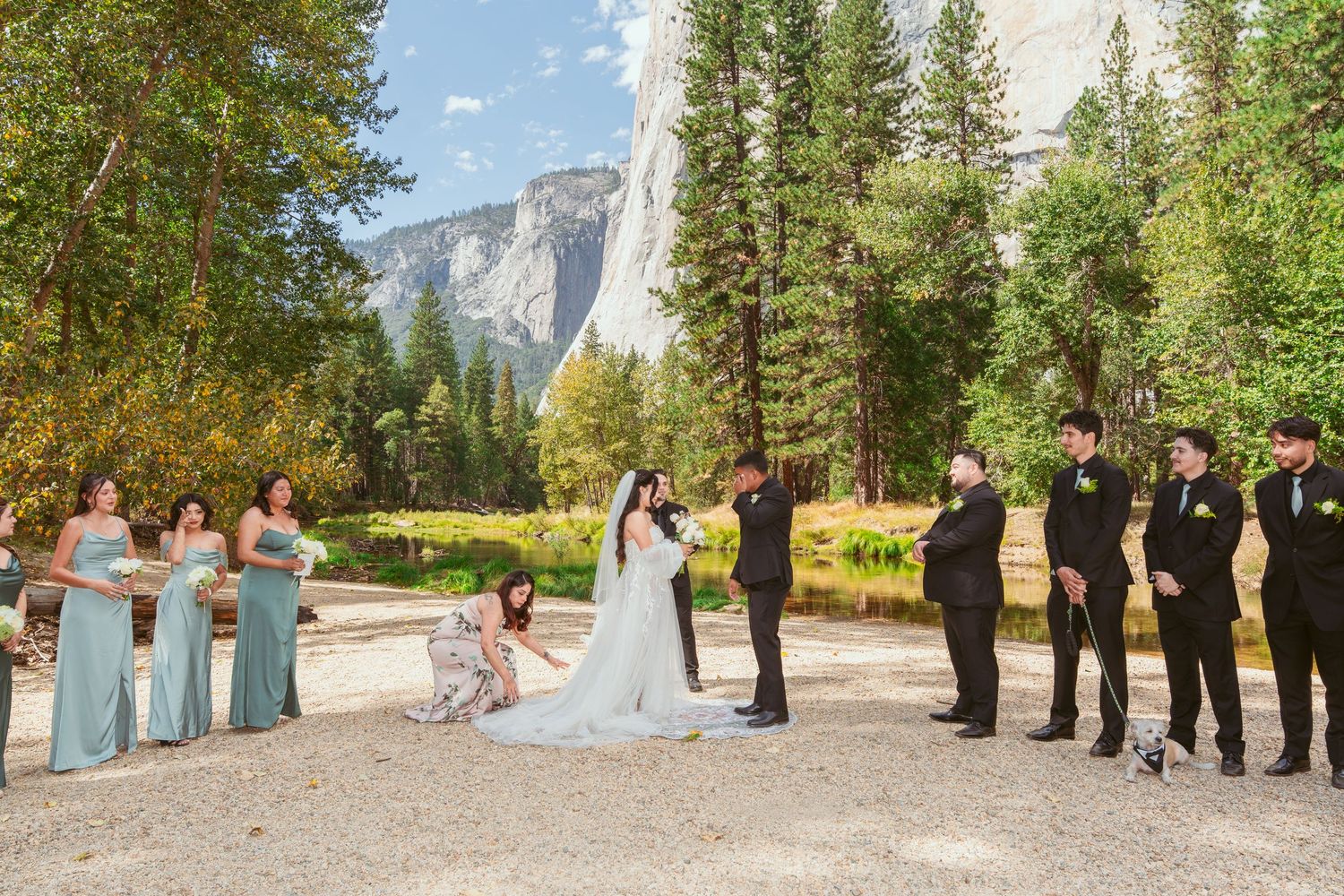Wedding ceremony group photo with El Capitan rock formation visible in the background.