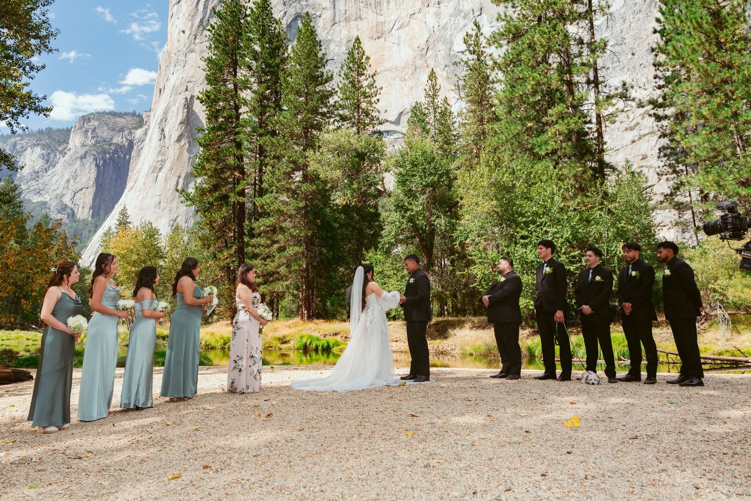 A panoramic view of a wedding ceremony at Yosemite National Park with El Capitan in the background.