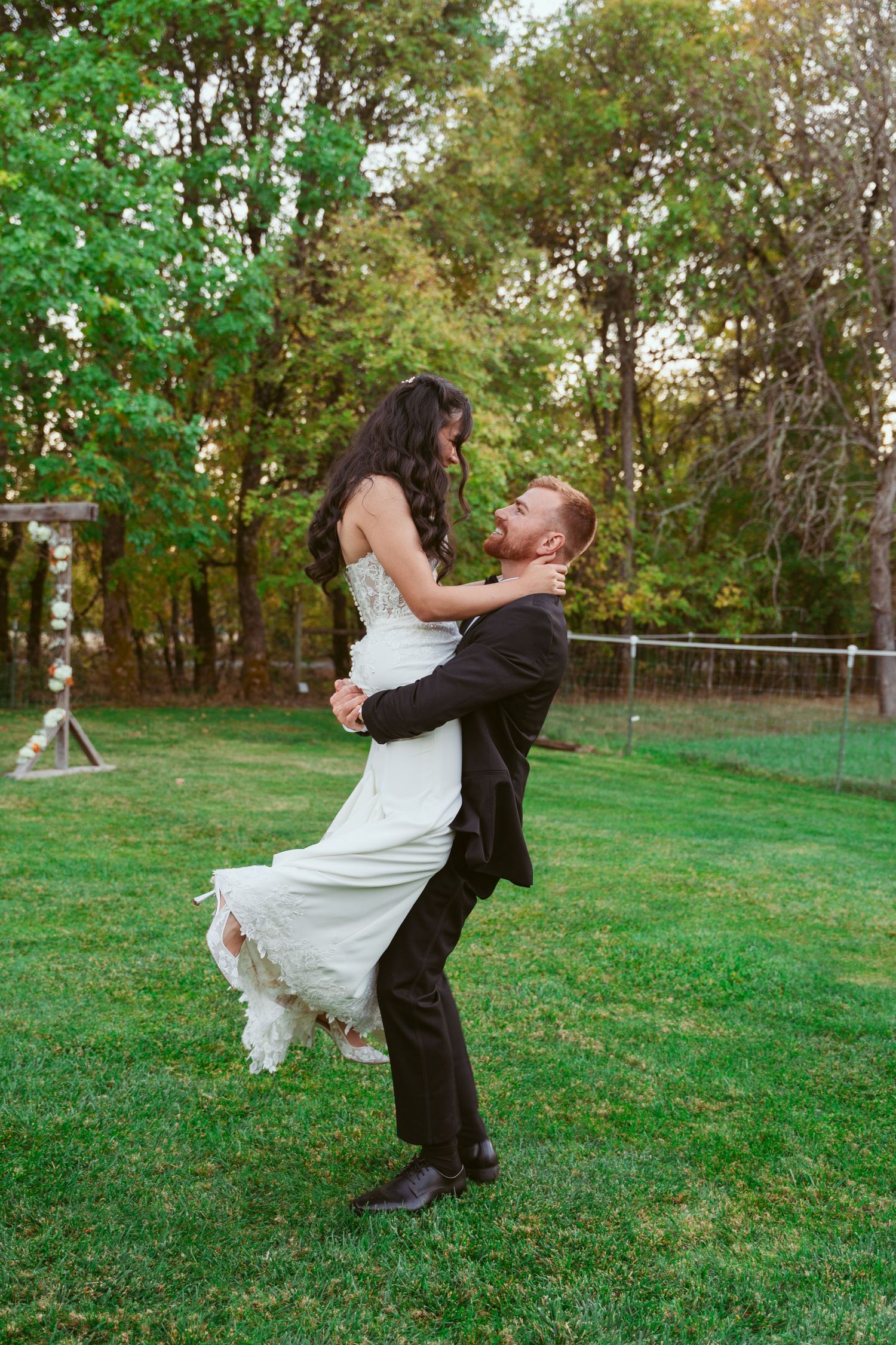 Romantic sequence of a couple dancing and spinning on grass during their wedding photoshoot.