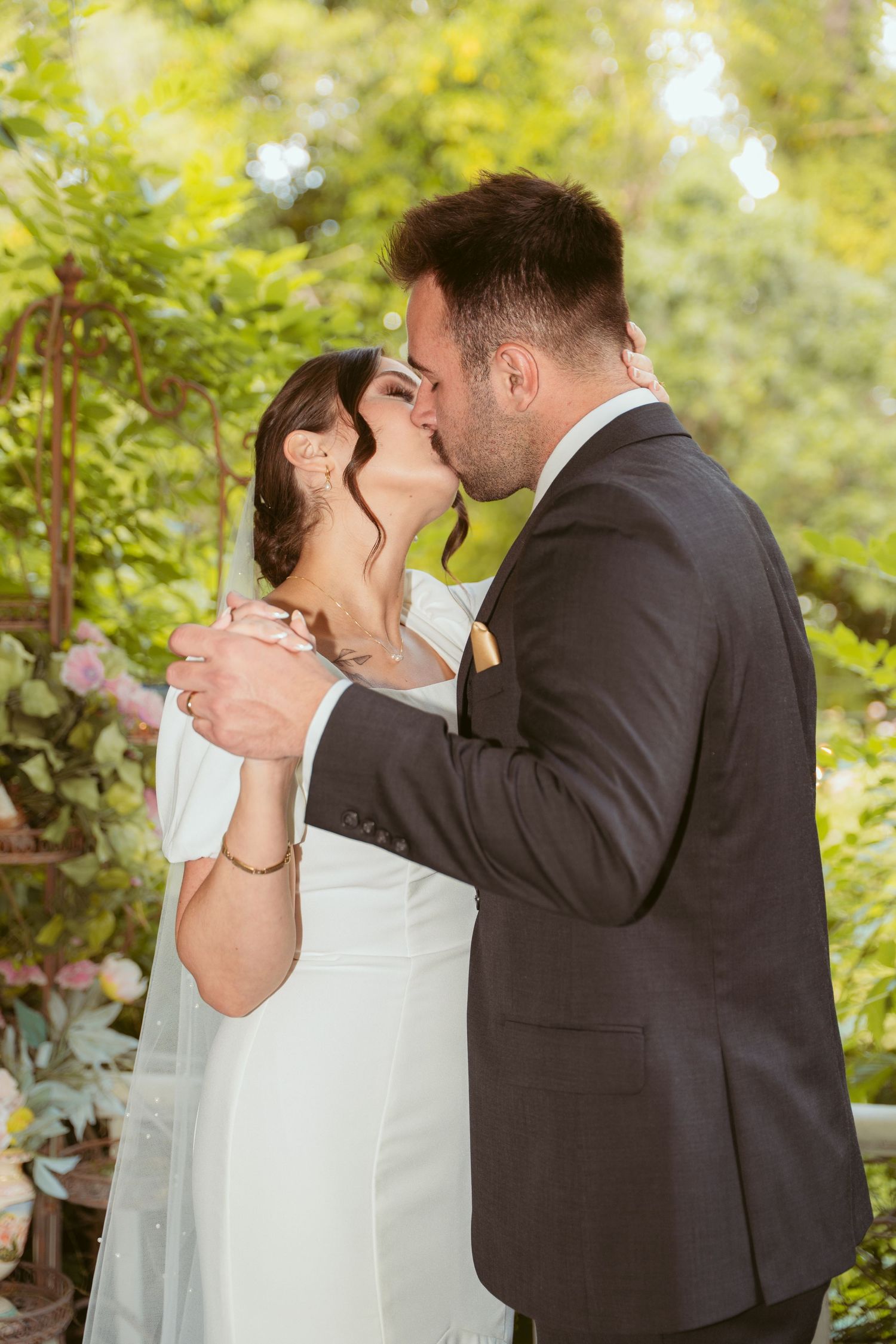 Intimate wedding portraits captured in a sunlit garden setting.