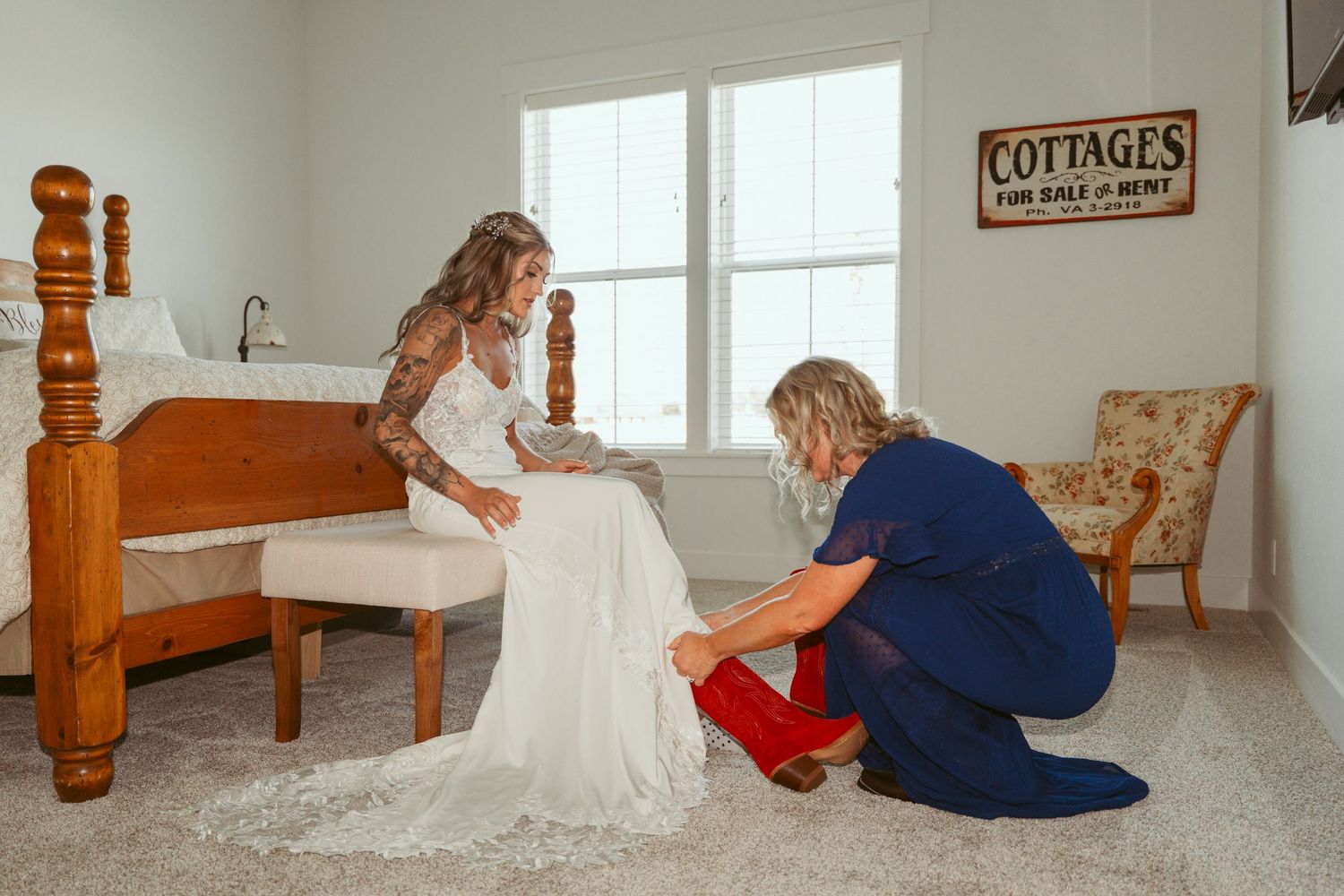 Wedding preparation scene in a bright white room with a dress and red boots.