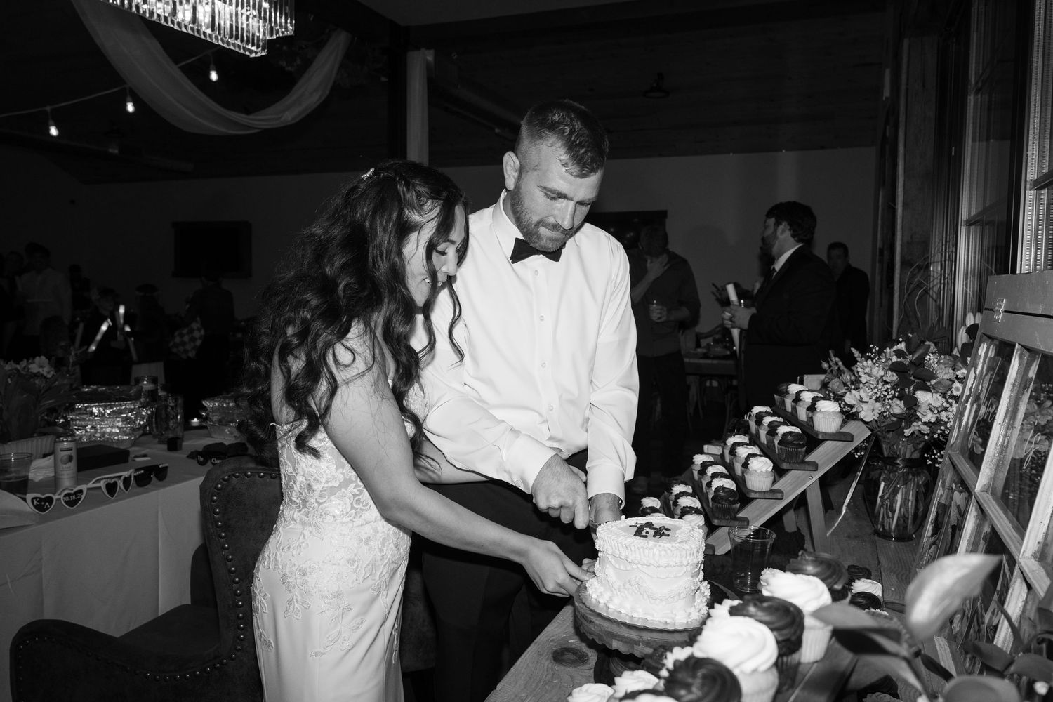 Wedding cake cutting ceremony with multiple tiers and decorative details.