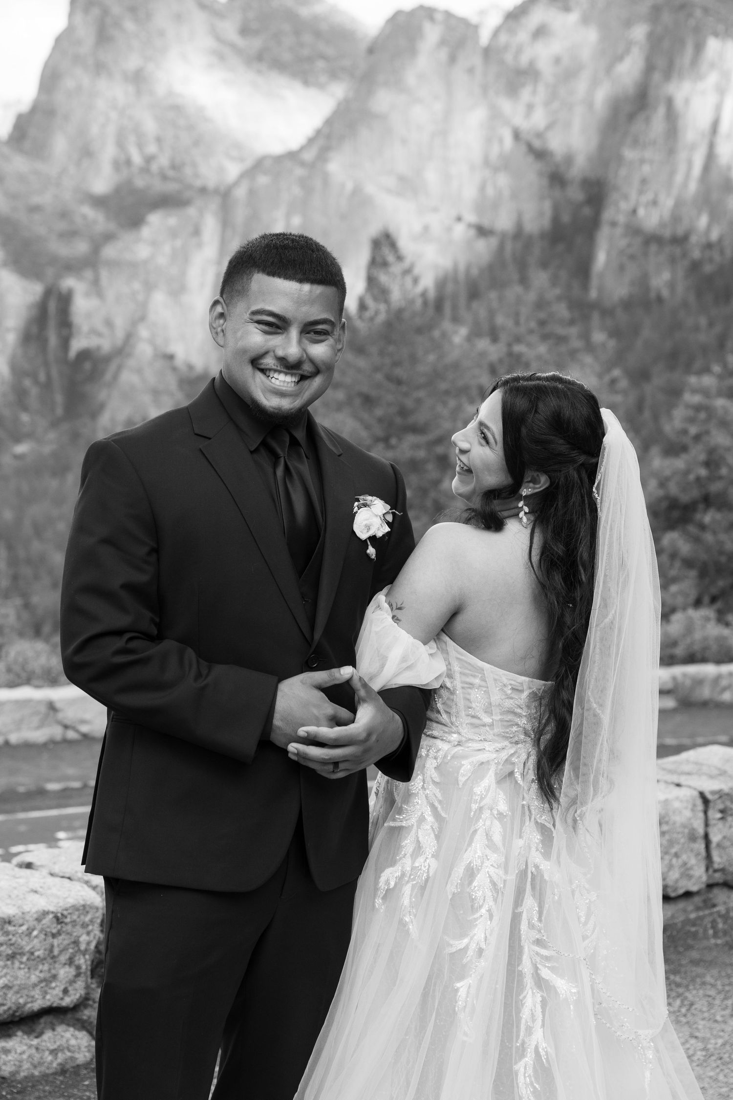 Happy couple shares joyful laughter during their wedding photoshoot in Yosemite Valley.