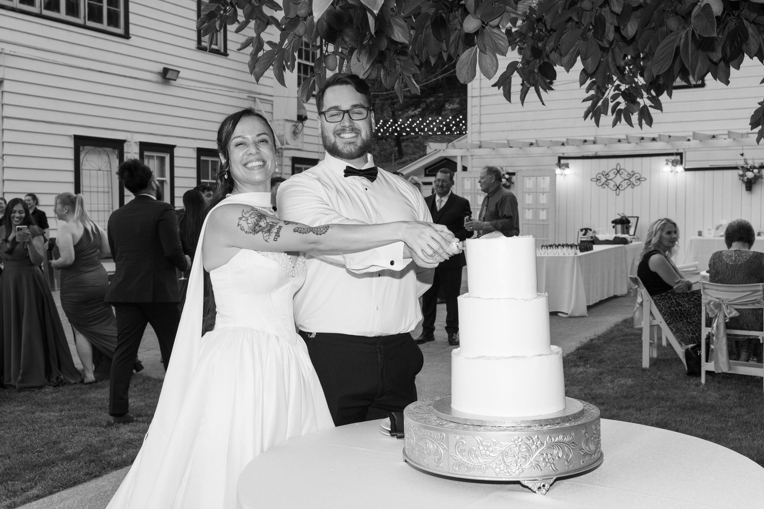 Wedding reception collage showing black and white moments of cake cutting and dancing celebrations.