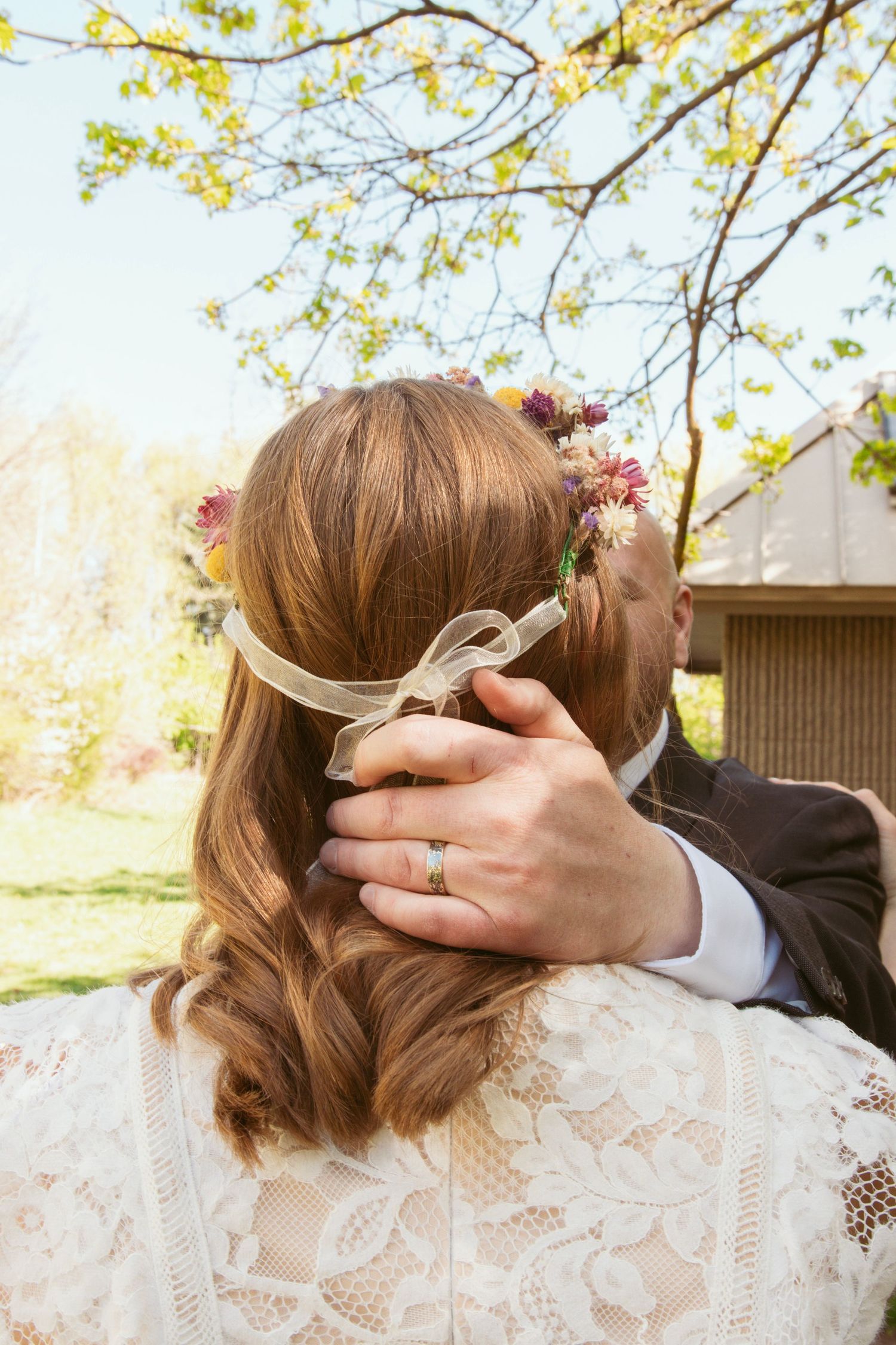 Close-up details of lace wedding dress and tender moments during spring ceremony.