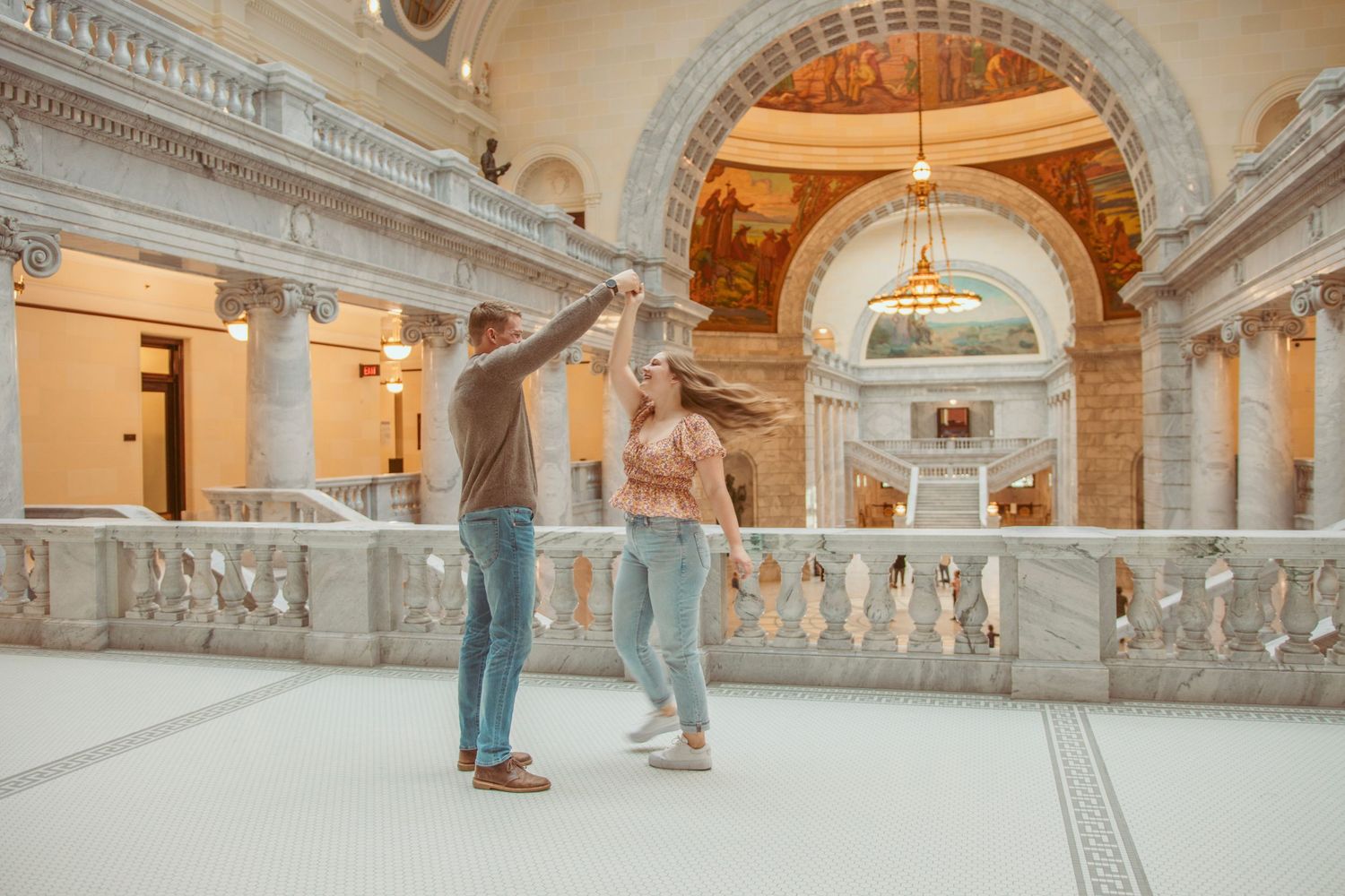 Elegant interior hallway with ornate classical architecture and arched ceilings.