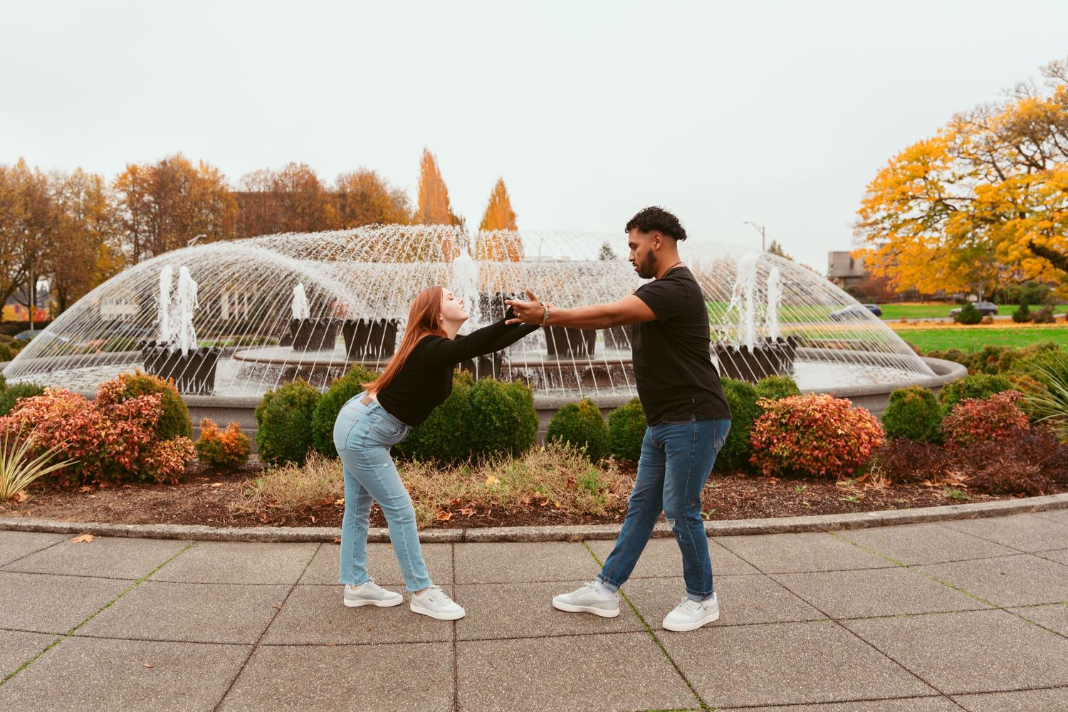 Series of dance poses photographed against fall foliage and fountain background.