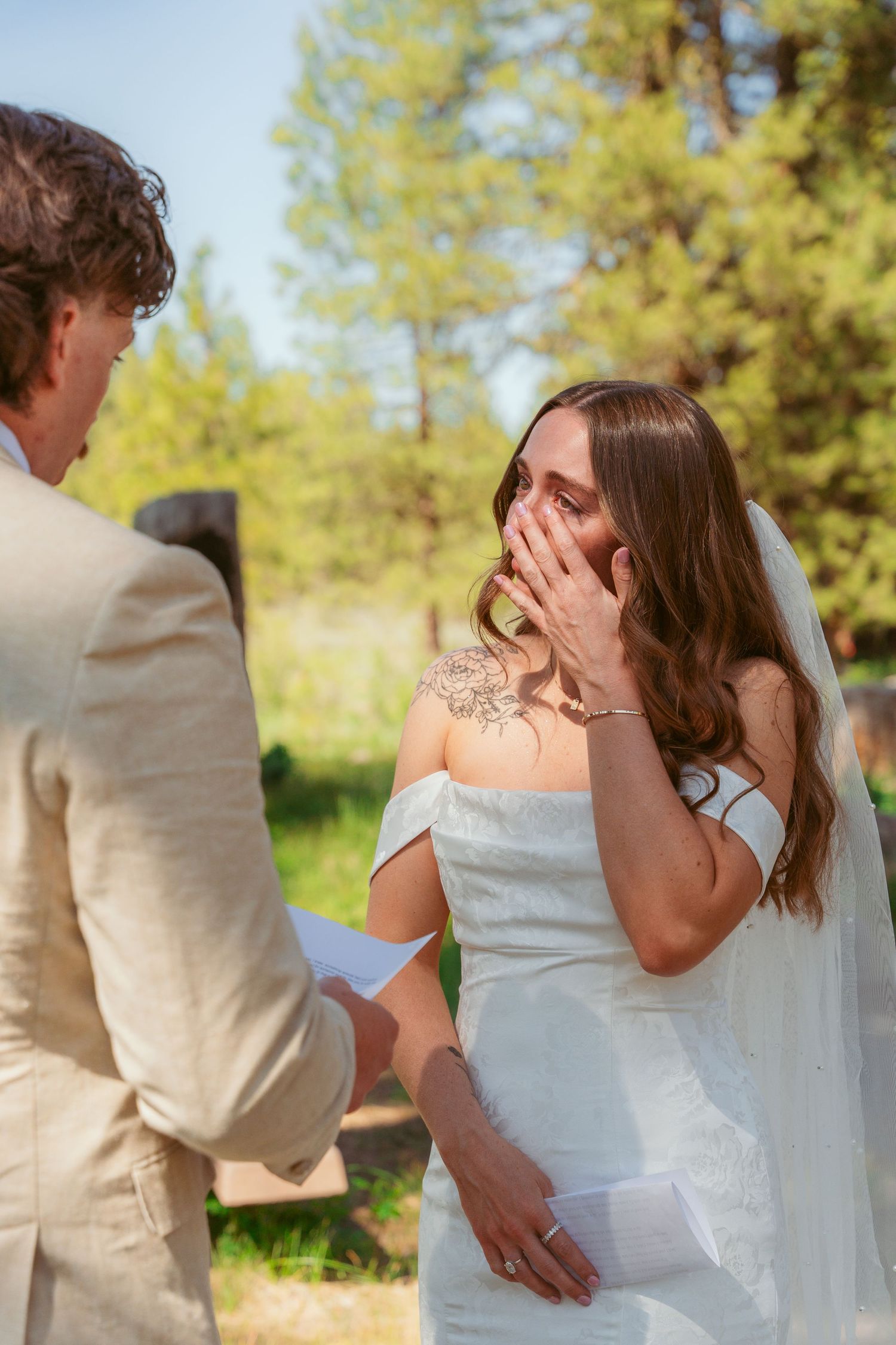A tender moment shared between a couple during their outdoor wedding ceremony.