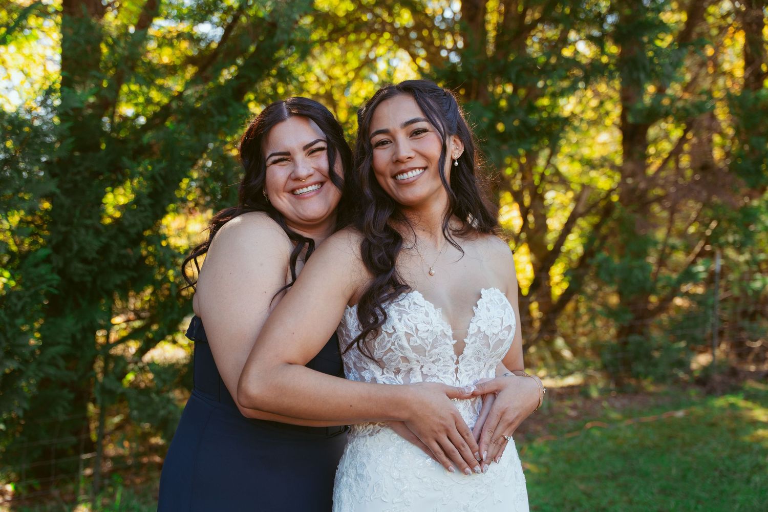 Candid moment between two people sharing laughter during outdoor wedding photoshoot.