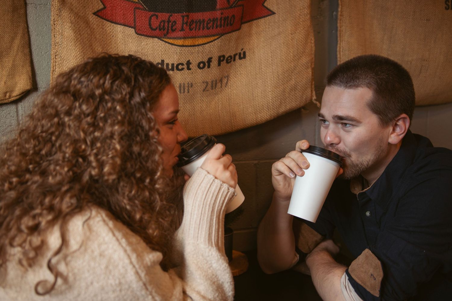 Couple sharing romantic moment in rustic cafe setting.