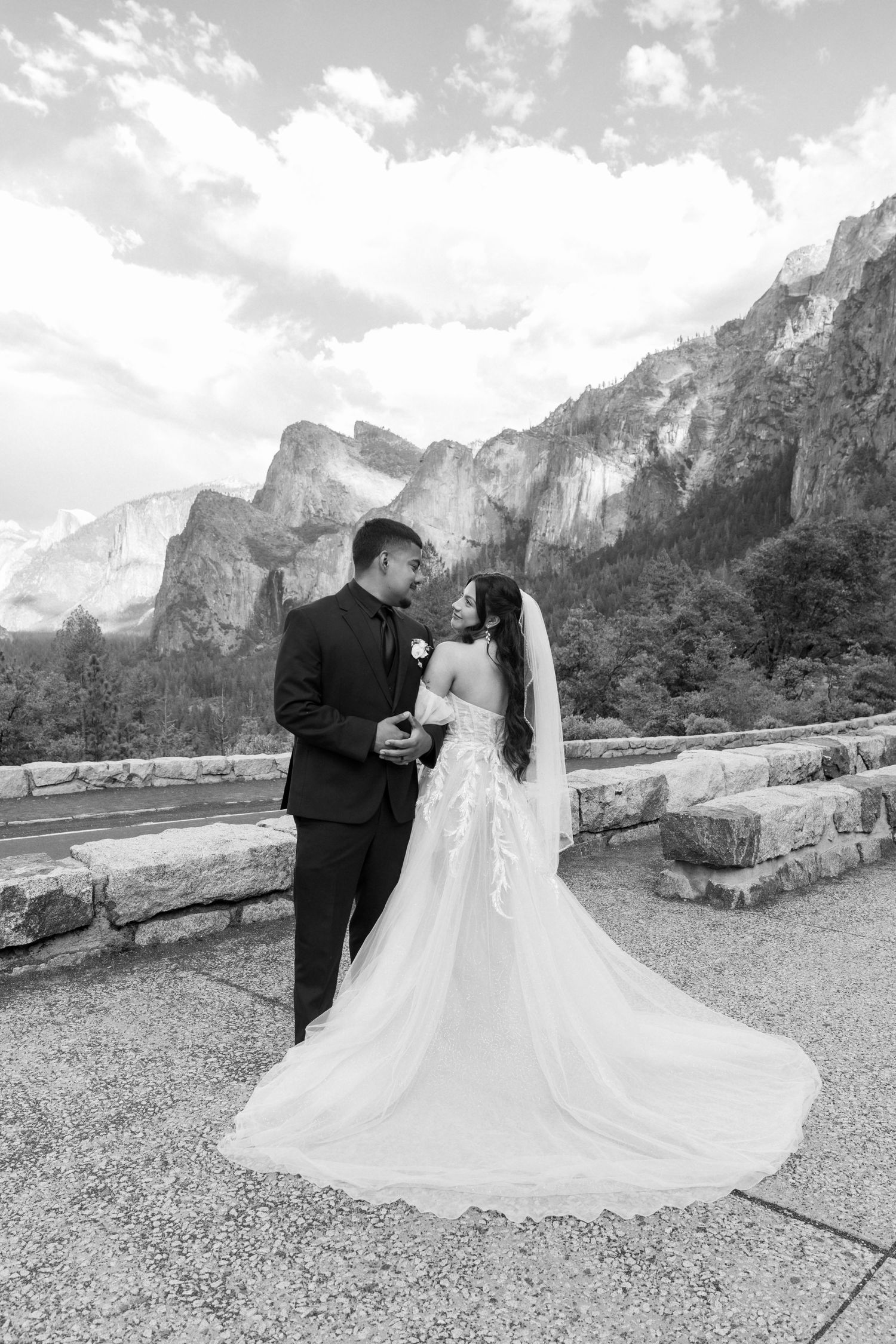 Wedding couple poses for romantic photos at Yosemite Valley with El Capitan in the background.