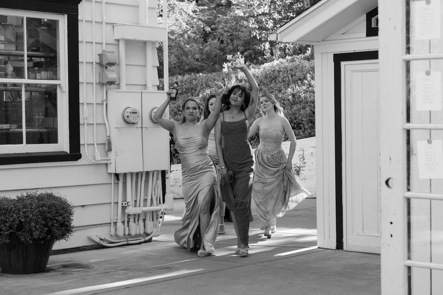 White clapboard building serves as backdrop for outdoor wedding reception setup.