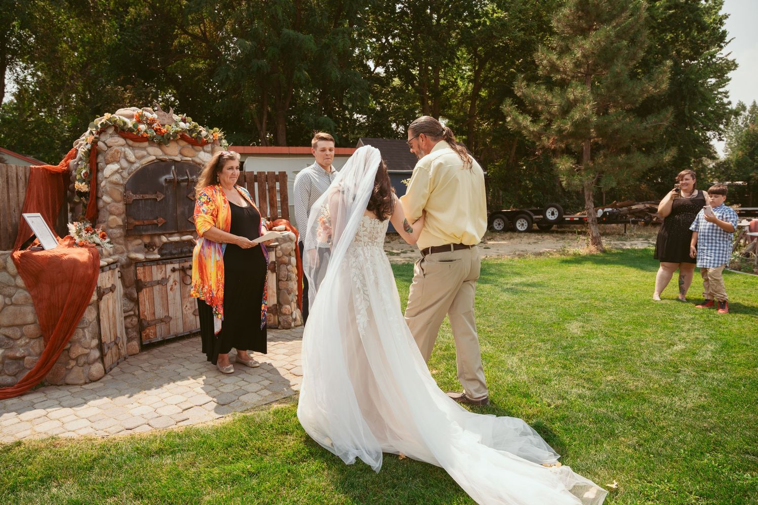 Wedding celebration taking place on a grassy lawn with guests in attendance.