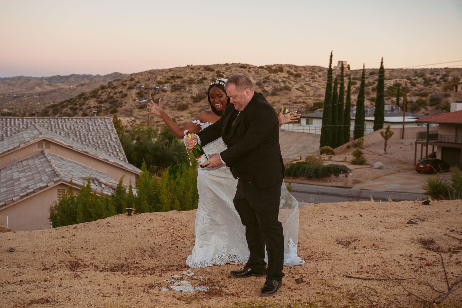 A celebratory dance between newlyweds on a hilltop at dusk.