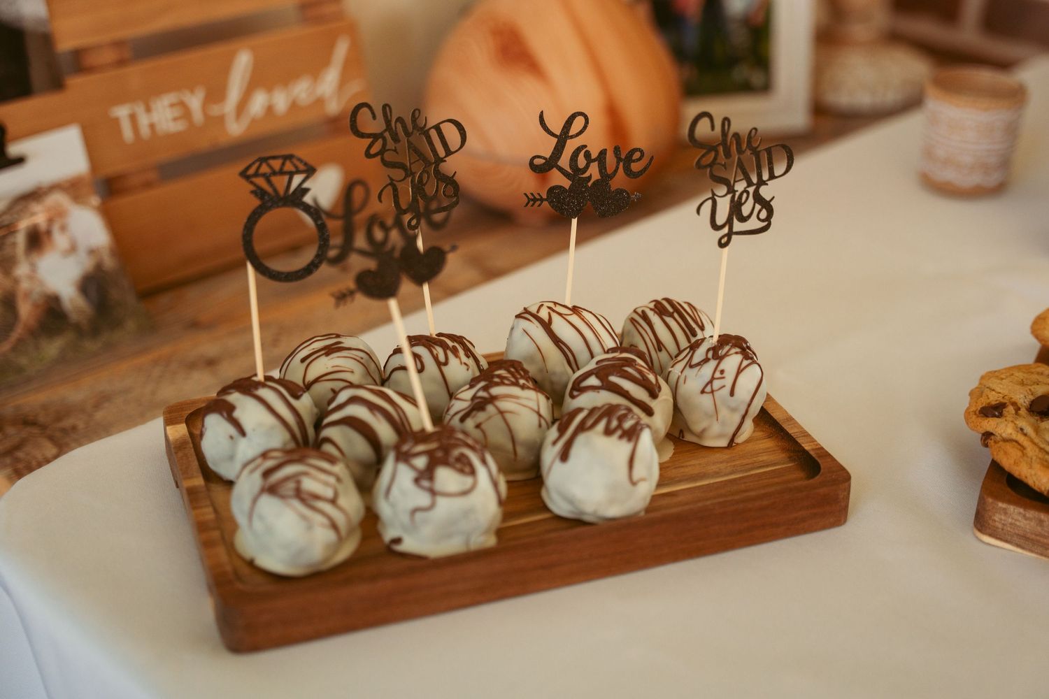 Rustic wooden wedding decor with love signs and white pumpkin decorations.