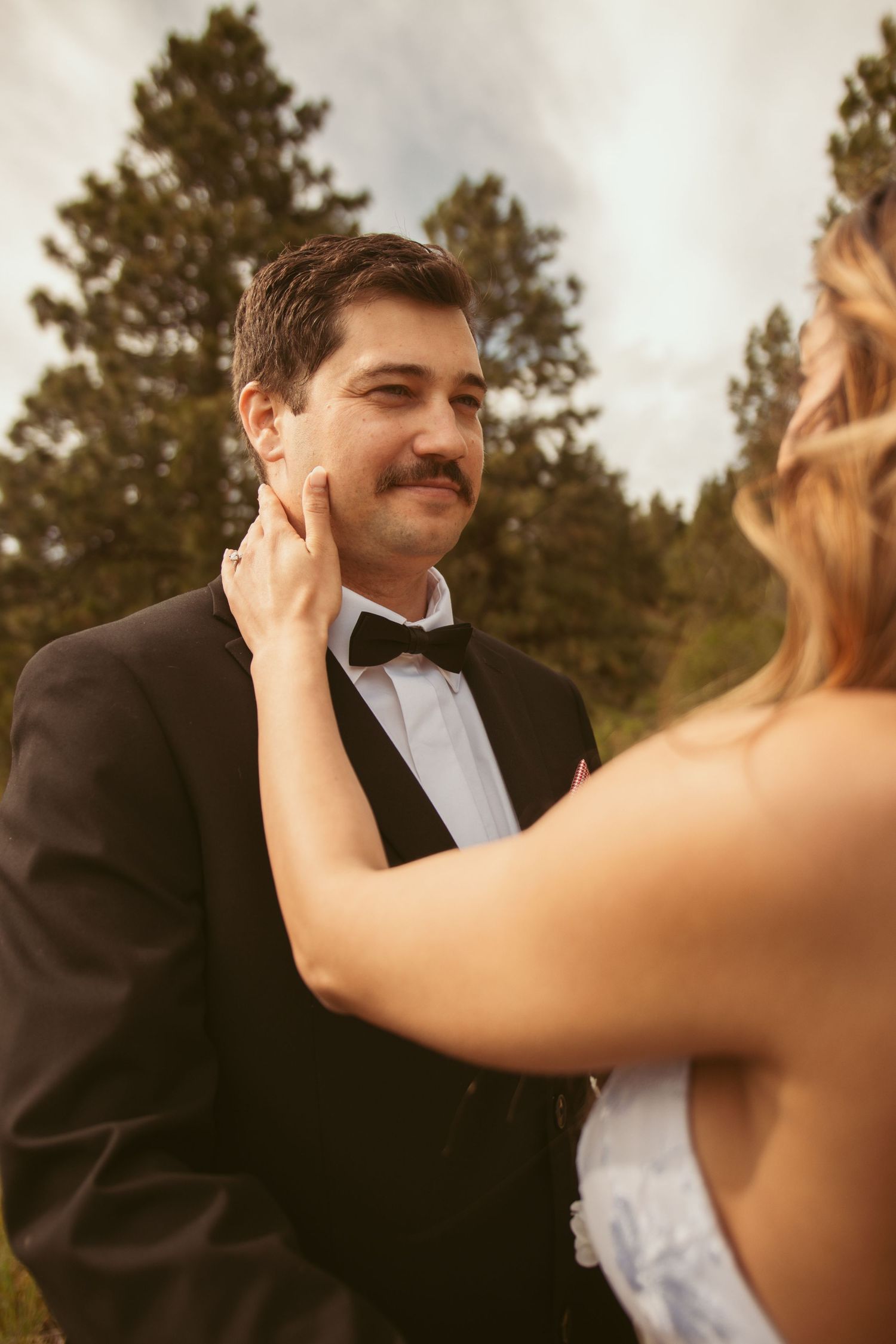 A romantic sequence of wedding photos showing tender moments between a couple in formal attire.