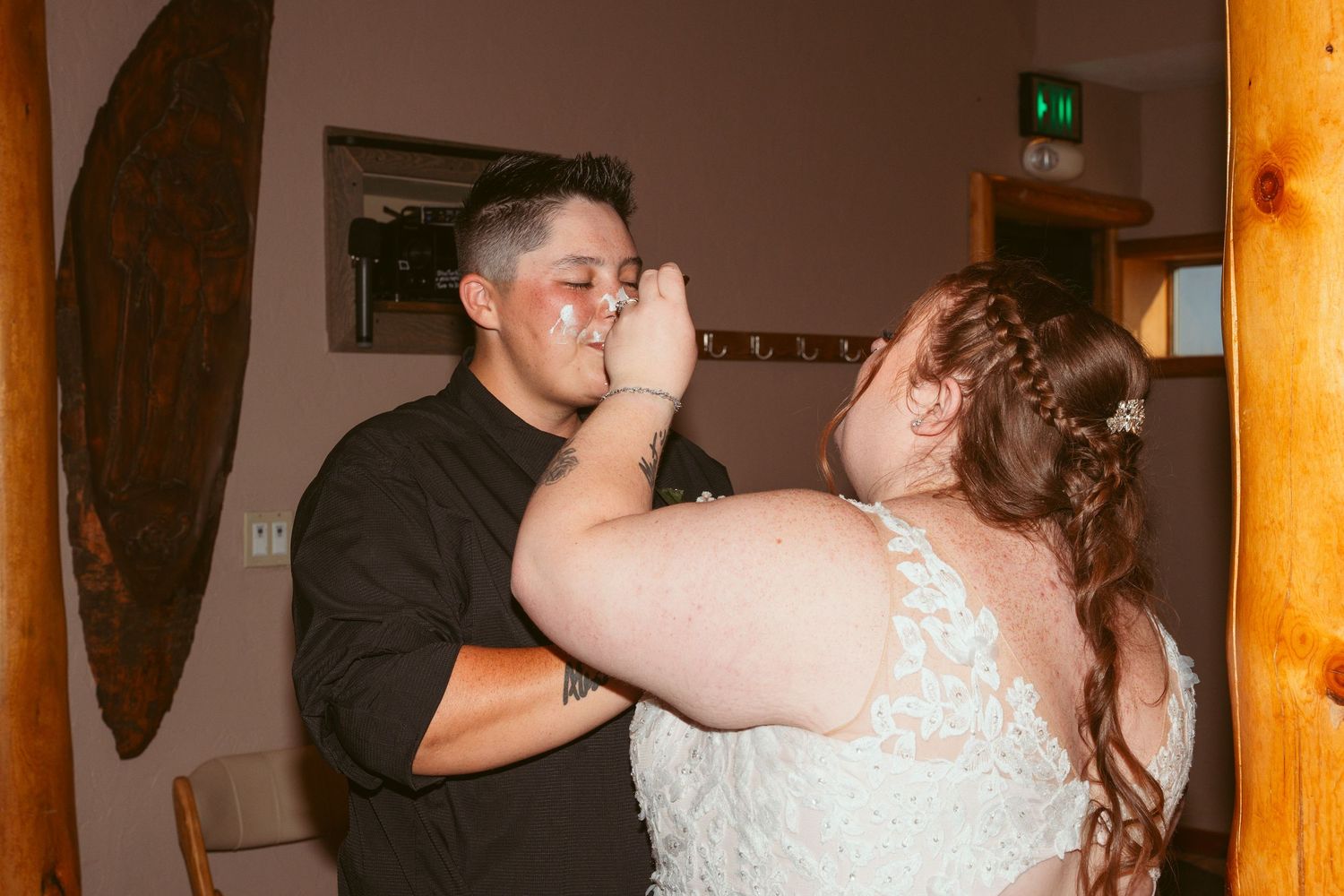 Newlyweds sharing cake during traditional wedding cake feeding moment.