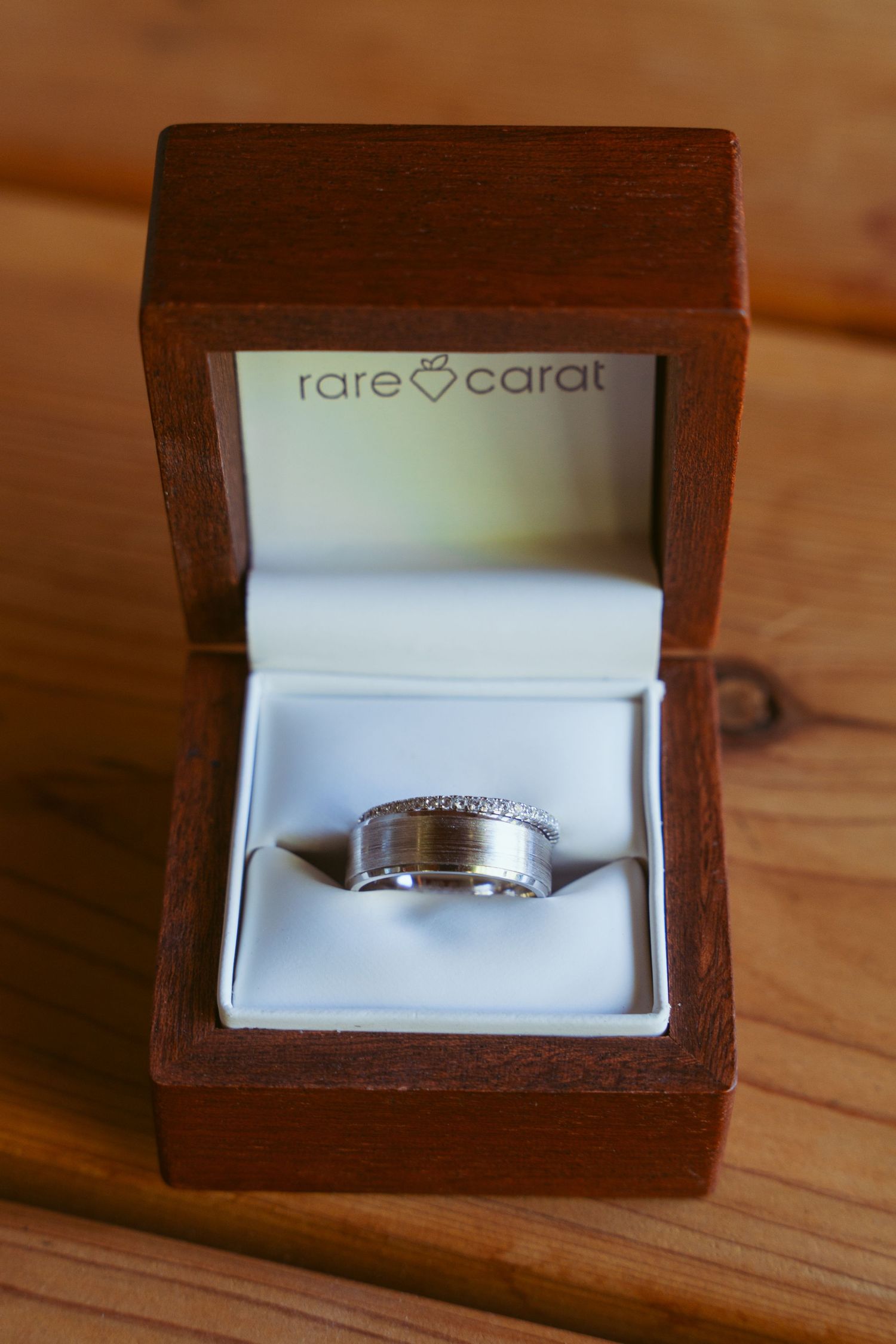Wedding ring displayed in an elegant wooden Rare Carat jewelry box.