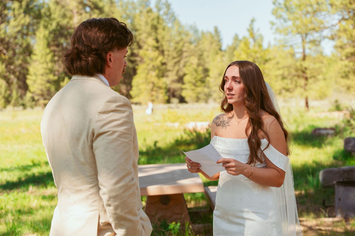 Natural candid moments between newlyweds during their outdoor forest first look session.